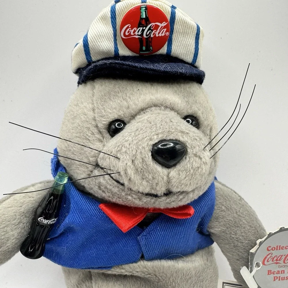Coca-Cola collectible bean‎ bag plush seal from 1998, wearing a delivery outfit